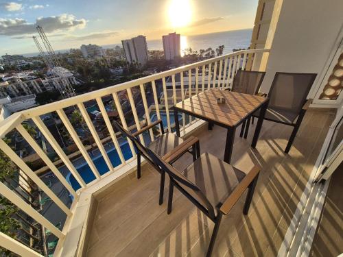 a balcony with a table and chairs and the ocean at Vibre Canaris - Las Americas in Playa de las Americas