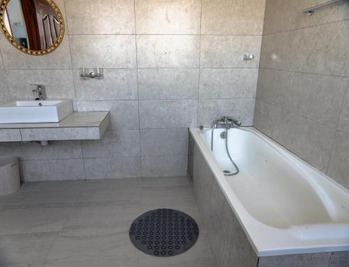 a bathroom with a tub and a sink at Ngao #220 Swara Ranch in Nanyuki