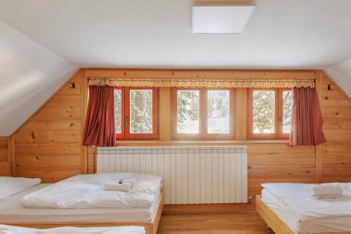 Postelja oz. postelje v sobi nastanitve Chalet Pokljuka