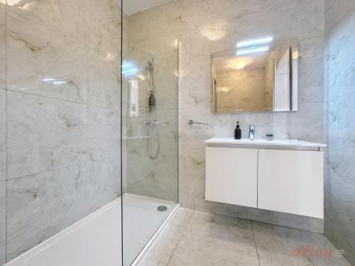 a bathroom with a shower and a tub and a sink at St Julians Mensija Valley Suites and Apartments in St. Julianʼs