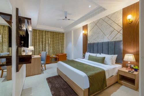 a hotel room with a bed and a television at Arch The Venus - Free Airport Pickup or Drop in New Delhi