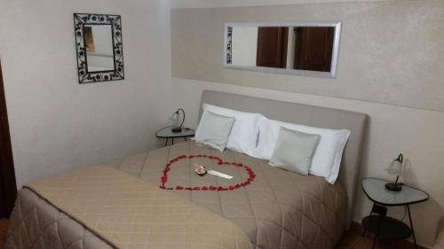 a bedroom with a bed with a clock on it at Villa Laura B&B in Fossano