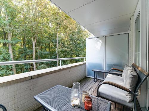 a screened in porch with a table and a couch at Holiday Home in Koudekerke near the Beach in Koudekerke