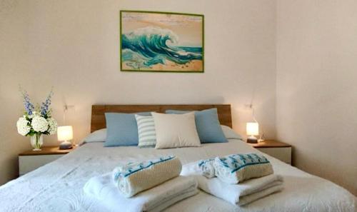a bedroom with a large bed with two lamps at La Terrazza In Centro Dorgali in Dorgali