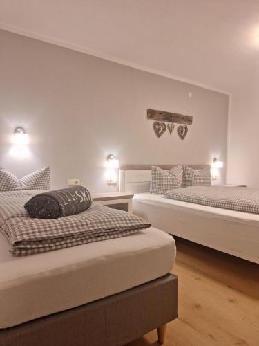 a bedroom with two beds and a wall at Piz Buin in Kappl