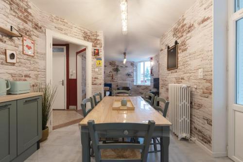 a dining room with a wooden table and chairs at The workshop in Metz