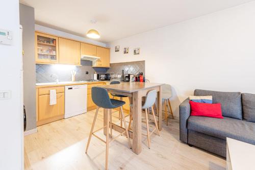 a kitchen and living room with a table and a couch at 2 Rue du Parc in Annecy
