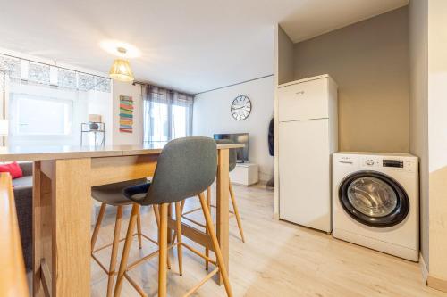 a kitchen with a counter and a washing machine at 2 Rue du Parc in Annecy