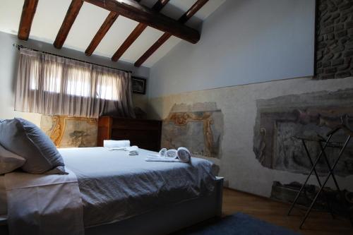 a bedroom with a bed with towels on it at Guest House Dell'Affresco in Reggio Emilia