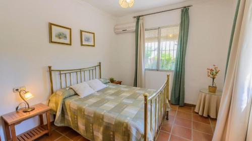 a bedroom with a bed and a window at El Olmo Posadas by Ruralidays in Posadas