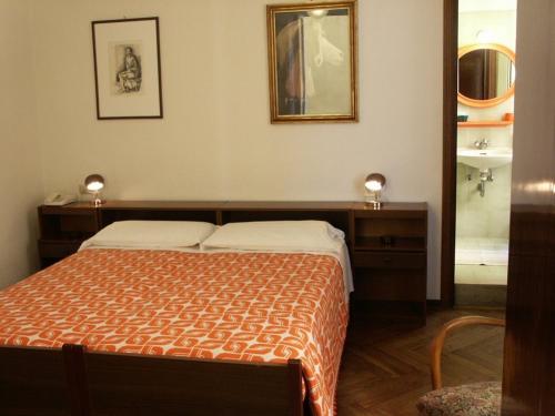 Postel nebo postele na pokoji v ubytování Albergo Corona