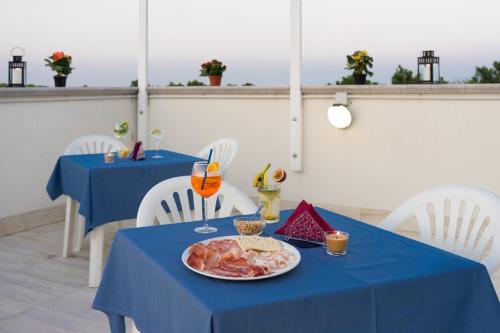 a blue table with a plate of food on it at Regina Hotel e Ristorante in Punta Marina