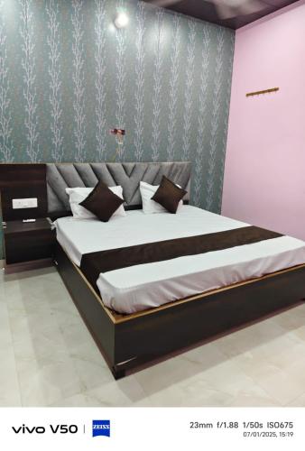 a bedroom with a large bed in a room at Pushpanjli grand inn in Ayodhya