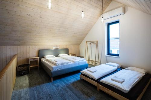 a bedroom with two beds and a window at Zastávka Vlkov in Vlkov