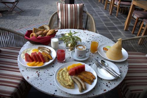 a table with plates of breakfast food on it at Temple Tree Resort & Spa, Pokhara in Pokhara