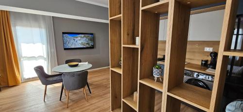 a small room with a table and chairs in a room at By The Pool Apartments #10 in Velingrad