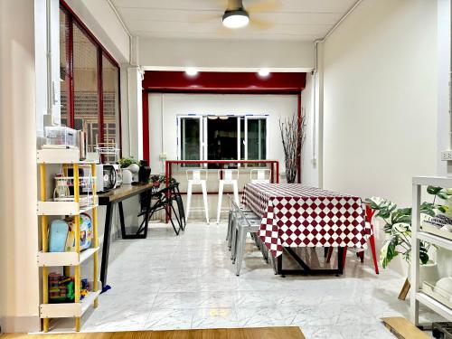 a living room with a table and chairs in it at อมรรัตน์Room in Pathum Thani