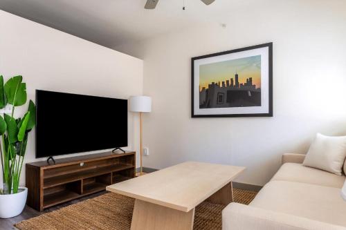 a living room with a flat screen tv and a couch at Kasa Love Field-Medical District Dallas in Dallas