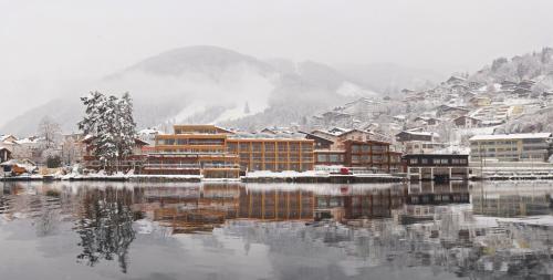 a town on a lake in the snow at Seevilla Freiberg in Zell am See