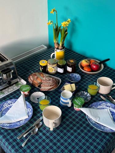 a table topped with plates of food and fruit at The Artist's house in Oxford