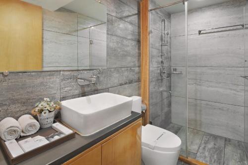 a bathroom with a sink and a toilet and a shower at Treat Beach Resort in Bordi