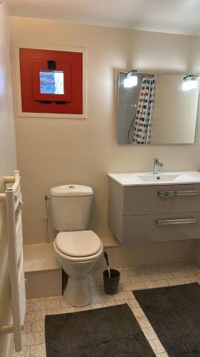 a bathroom with a toilet and a sink at La Forge de Paul et Virginie in Mainneville