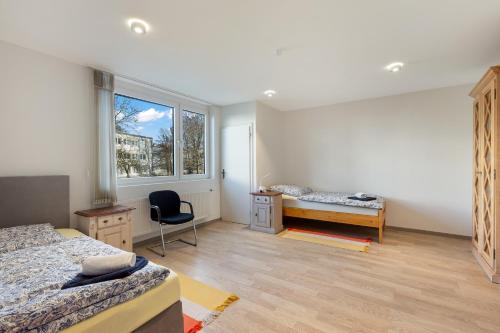 a bedroom with two beds and a desk and a window at Ferienwohnung Bernhard in Wermelskirchen
