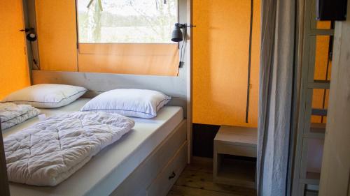 two beds in a room with a window at Glamping Terme Tuhelj in Tuheljske Toplice