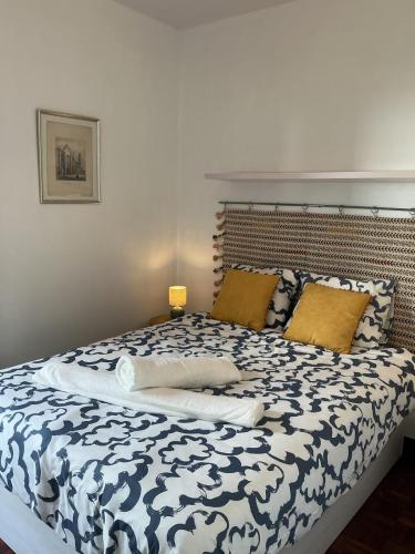 a bedroom with a bed with a blue and white comforter at Casa Žerotín in Funchal