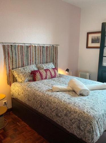 a bedroom with a bed with a headboard and pillows at Casa Žerotín in Funchal