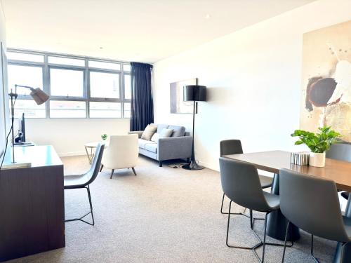 a living room with a table and chairs and a couch at Chatswood Exeutive Condo - 2 Bedrooms 2 Bathrooms with King Bed in Sydney