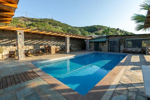 a villa with a swimming pool and a house at Talizeti Home - Adults Only in Sarti