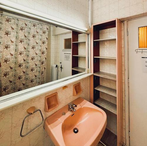 a bathroom with a sink and a mirror and shelves at Imperial 5 in Athens