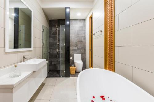 a white bathroom with a sink and a shower at Villa Coastar 002 Hồ Tràm in Ho Tram