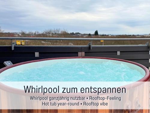 a hot tub on the roof of a building at Panorama Penthouse mit Dachterrasse - Sauna & Whirlpool in Karlsruhe