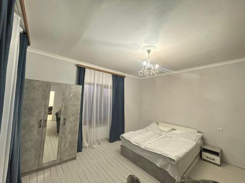 a bedroom with a bed and a mirror in it at AparanQ