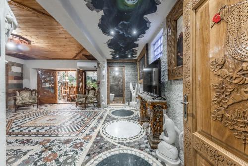 a living room with a tile floor and a ceiling at Kanuni Authentic Albanian House by PikHost in Shkodër