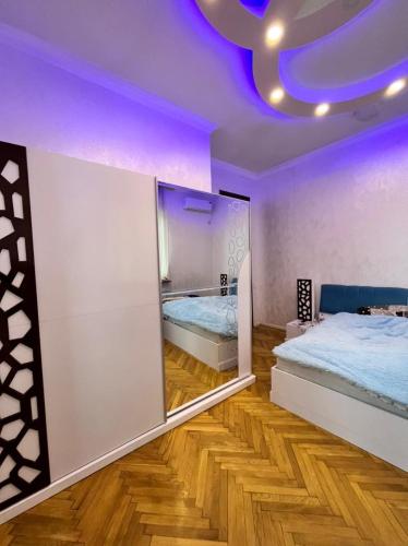 a bedroom with two beds and a purple ceiling at Kobuleti stay inn in Kobuleti