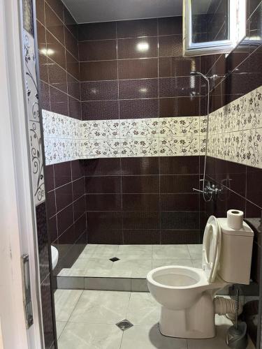a bathroom with a toilet and a shower at Kobuleti stay inn in Kobuleti