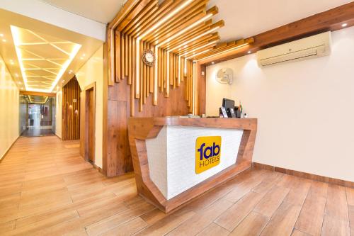 a fast food restaurant with a reception desk in a hallway at FabHotel Aishwarya in Kota