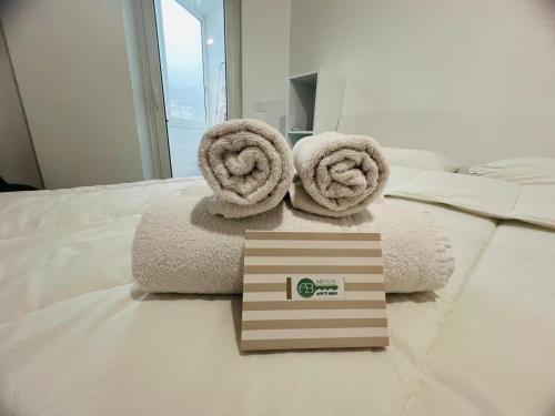 a room with towels and a box on a bed at Suite Borgo 112 - Sanremo in Sanremo
