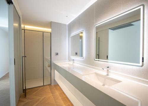 a bathroom with two sinks and a large mirror at Beachfront 267 3BR Condo with Pool View in Phuket