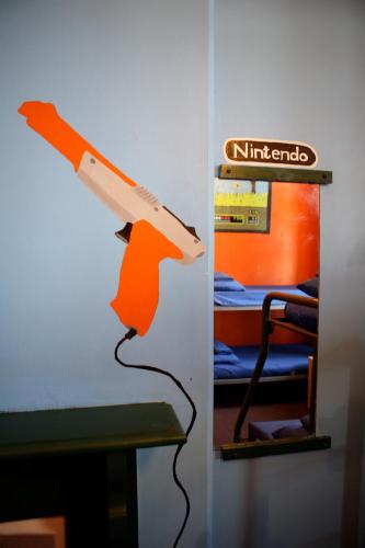 a gun hanging on a wall in a room at Old Fire Station Backpackers in Fremantle