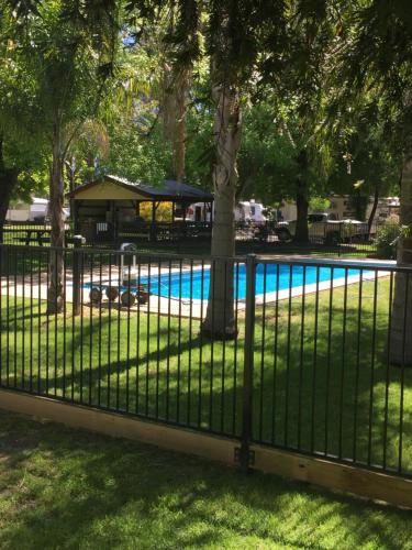a fence in front of a swimming pool at Wangaratta Caravan Park in Wangaratta
