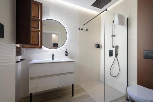 a bathroom with a sink and a shower at Escolástica Suites Centro in Granada