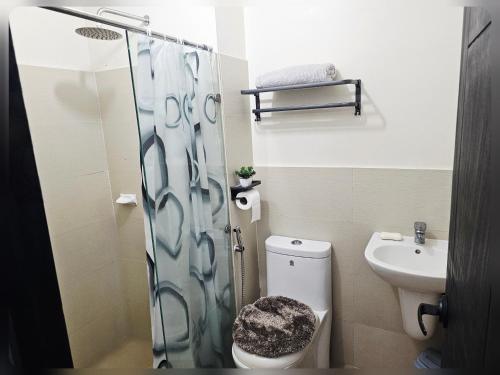 a small bathroom with a toilet and a sink at Paseo Verde Condo Unit in Las Pinas - Sleeps 2 Adults & 2 Children in Manila