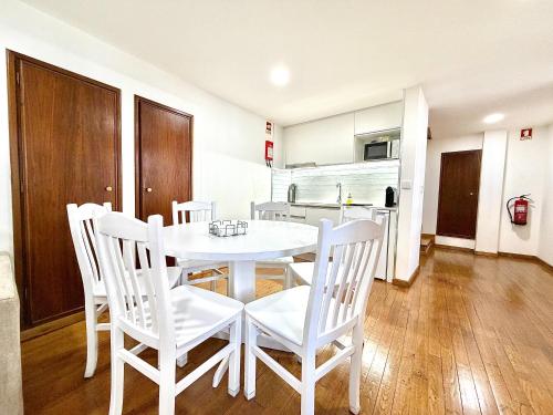 a white dining room table and chairs in a kitchen at Casa do Castello Chaves in Chaves