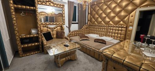 a large room with a couch and a table at Bali Colosseum Hotel in Belgrade