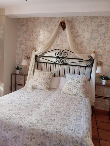 a bedroom with a large bed with a white bedspread at Casa Rural La Torre De Babel in Molinaseca