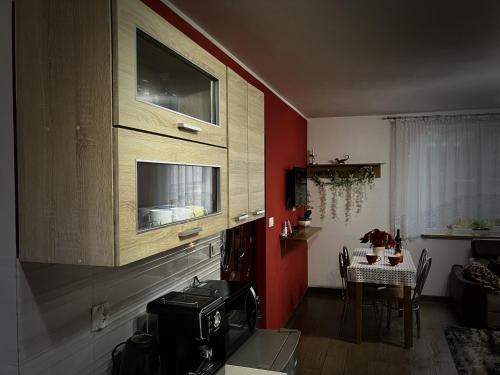 a kitchen with red walls and a sink in a room at Lazurowy Zakątek in Życiny